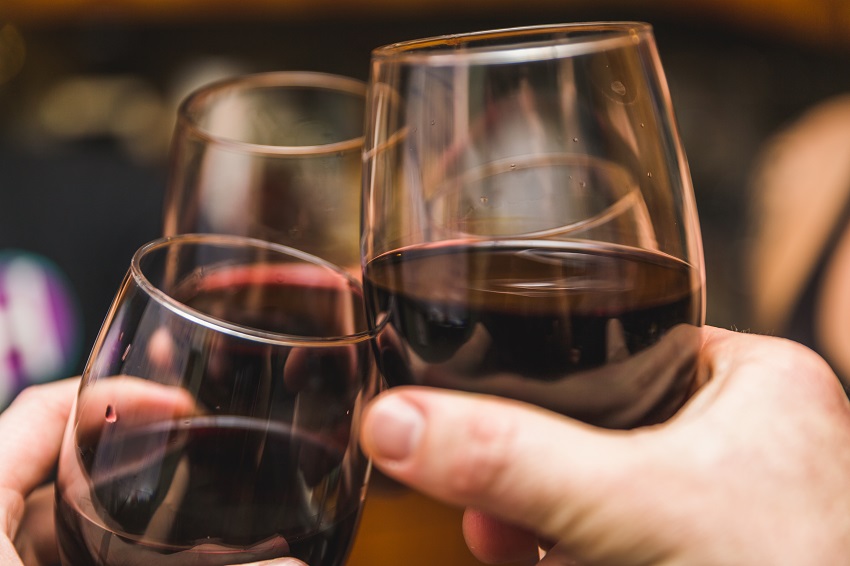 friends making a toast with red pinot wine