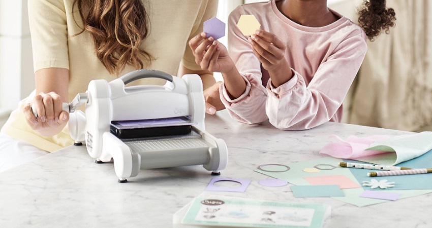 mom and daughter using die cutting machine