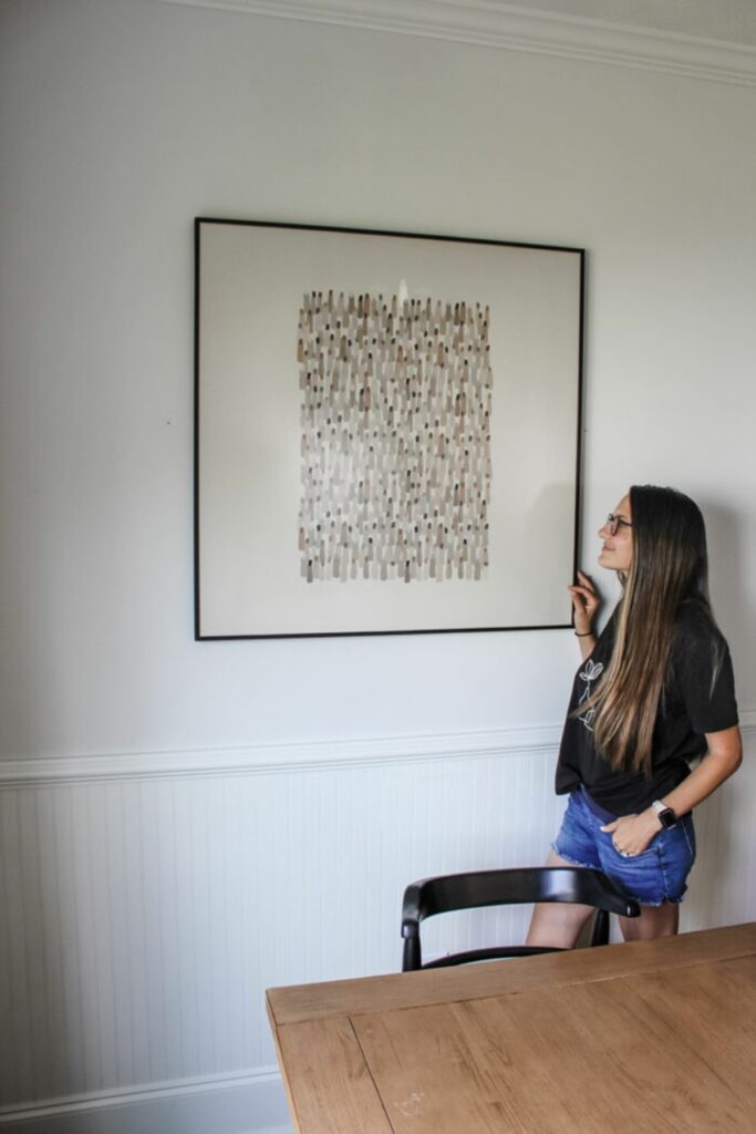 woman standing to a photo frame 