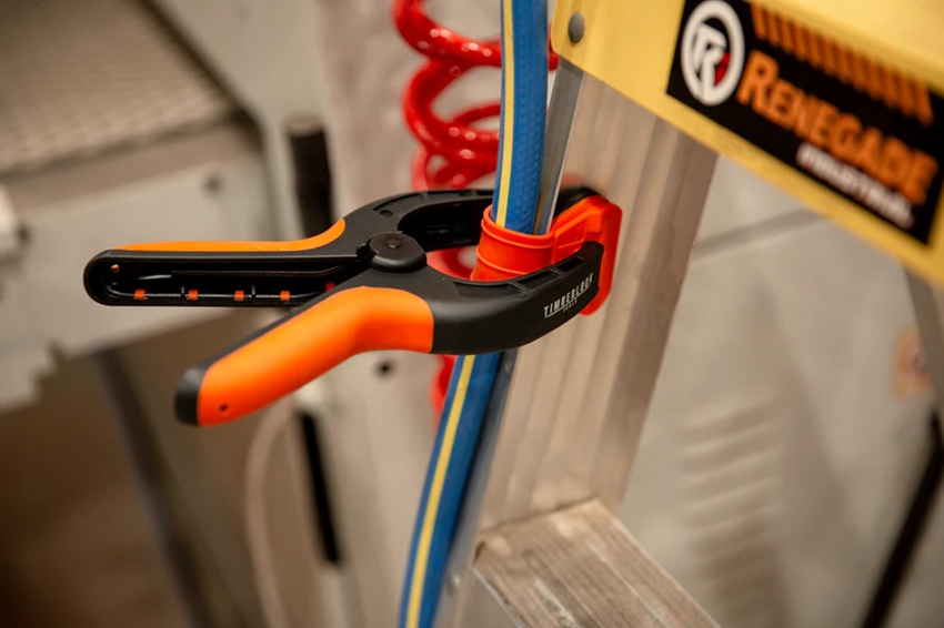 orange and black spring clamp holding on a cable